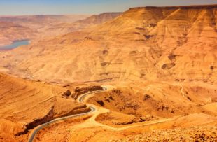 Photo of curvy road meandering along the route of the ancient King's Highway in the desert in Jordan, Middle East.