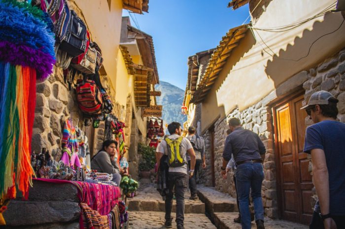 Traveller walking through the cobbled streets of Incan Cusco, Peru